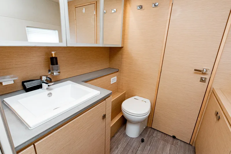 Libert'e Yacht Photos Pics Modern bathroom interior on 2020 Fountaine Pajot MY6 yacht, featuring sleek sink and toilet.