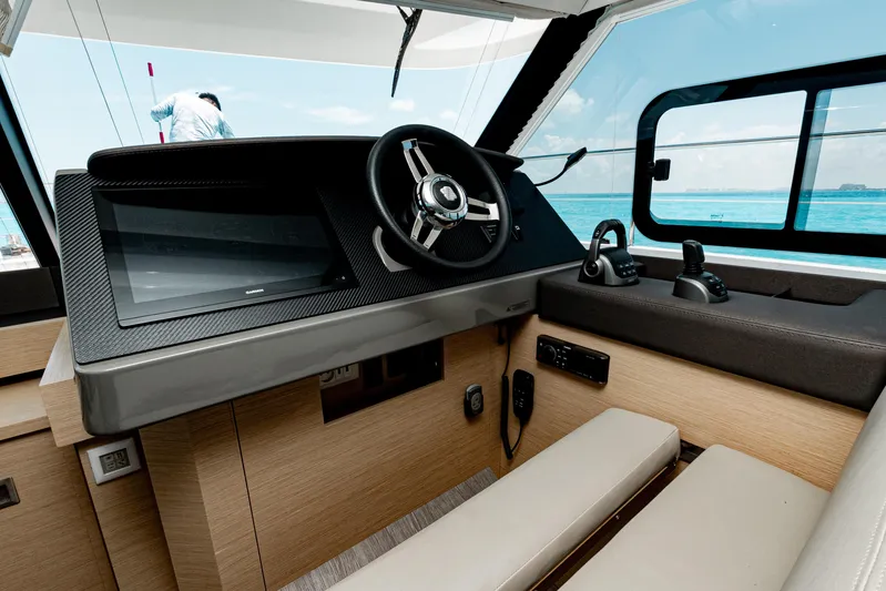 Libert'e Yacht Photos Pics Helm of 2020 Fountaine Pajot MY6 yacht with modern controls and ocean view.