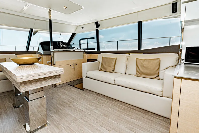 Libert'e Yacht Photos Pics Luxurious interior of 2020 Fountaine Pajot MY6 yacht with modern furnishings and panoramic windows.