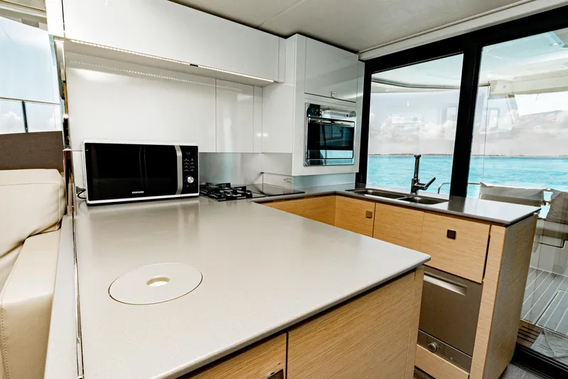 Libert'e Yacht Photos Pics Modern kitchen interior on 2020 Fountaine Pajot MY6 yacht with ocean view.