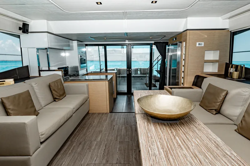 Libert'e Yacht Photos Pics Luxurious interior of 2020 Fountaine Pajot MY6 yacht with modern furnishings and ocean view.