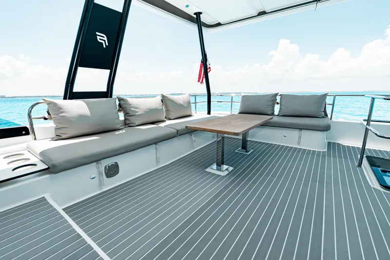 Libert'e Yacht Photos Pics Luxurious 2020 Fountaine Pajot MY6 yacht deck with seating and ocean view.