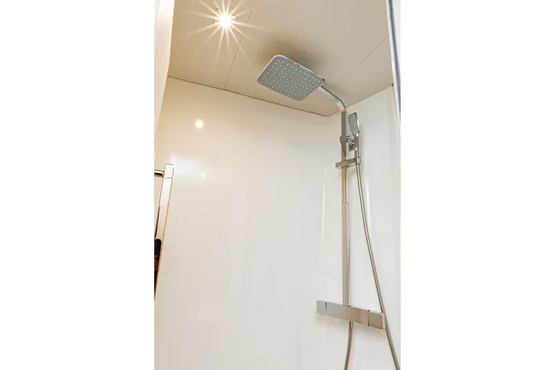 Libert'e Yacht Photos Pics Modern shower in 2020 Fountaine Pajot MY6 yacht, featuring sleek fixtures and bright lighting.