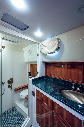 Marika Yacht Photos Pics Luxurious bathroom in 2011 Hunt Yachts 52 with glass shower and marble countertop.