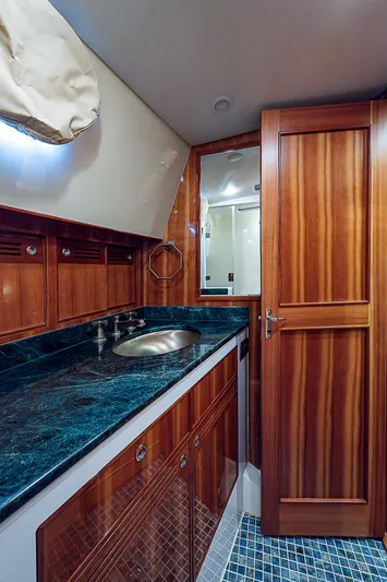 Marika Yacht Photos Pics Luxurious bathroom in 2011 Hunt Yachts 52 with wooden cabinetry and marble countertop.