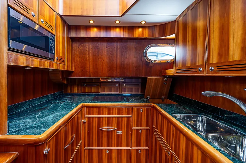 Marika Yacht Photos Pics Luxurious wooden kitchen interior of 2011 Hunt Yachts 52 with green marble countertops.