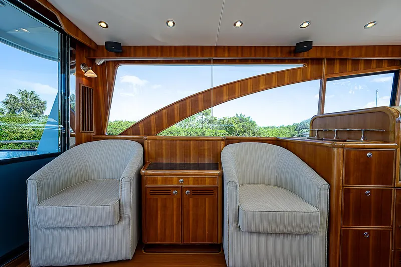 Marika Yacht Photos Pics Interior of 2011 Hunt Yachts 52 with two armchairs and wooden cabinetry.