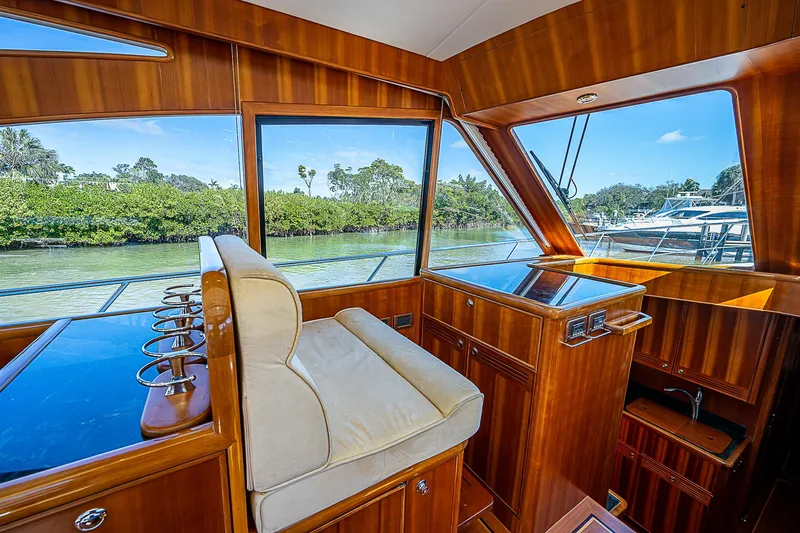 Marika Yacht Photos Pics Interior of 2011 Hunt Yachts 52, featuring luxurious wood finish and scenic waterway view.