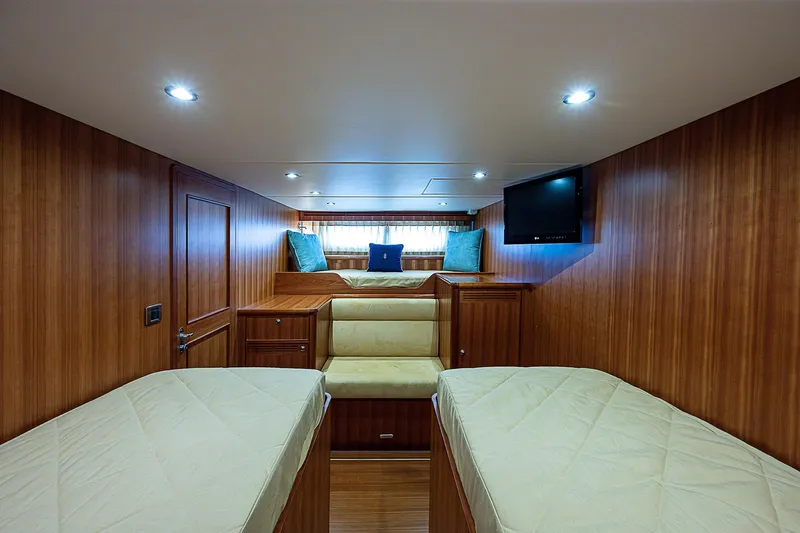 Marika Yacht Photos Pics Luxurious cabin interior of 2011 Hunt Yachts 52 with twin beds and TV.