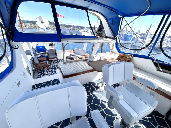  Yacht Photos Pics 1987 Marine Trader 44 Sunbridge Trawler interior with white seating and blue accents.