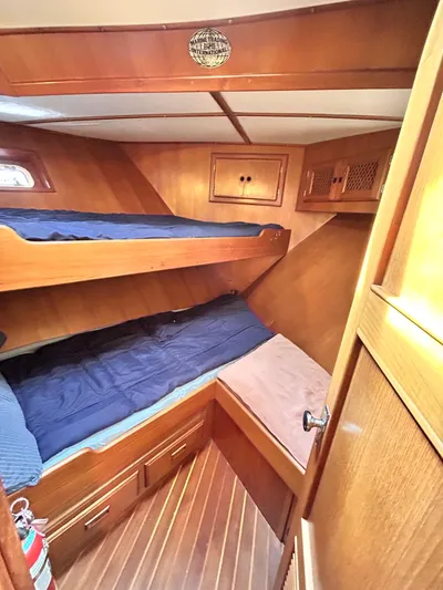  Yacht Photos Pics 1987 Marine Trader 44 Sunbridge Trawler cabin with wooden interior and bunk beds.