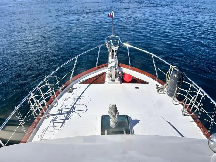  Yacht Photos Pics 1987 Marine Trader 44 Sunbridge Trawler bow view on calm water.