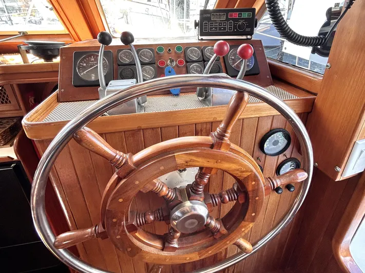  Yacht Photos Pics 1987 Marine Trader 44 Sunbridge Trawler helm with wooden wheel and control panel.