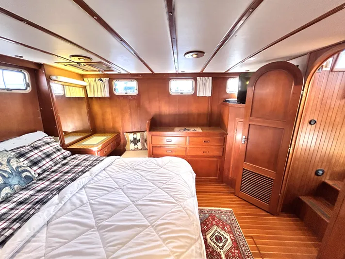  Yacht Photos Pics Cozy cabin interior of 1987 Marine Trader 44 Sunbridge Trawler with wood paneling and bed.
