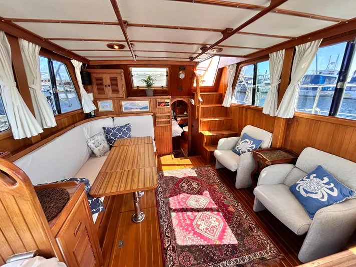  Yacht Photos Pics 1987 Marine Trader 44 Sunbridge Trawler interior with wood finish, seating, and nautical decor.