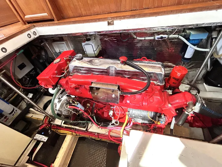  Yacht Photos Pics Engine compartment of a 1987 Marine Trader 44 Sunbridge Trawler, featuring a red engine.