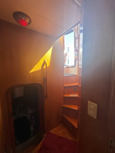 Brut Yacht Photos Pics Interior view of 1999 Krogen Trawler with wooden stairs and red light.