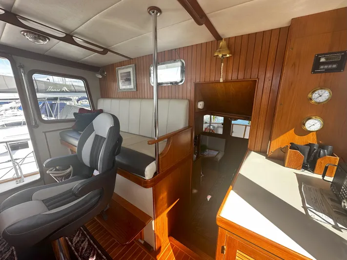 Brut Yacht Photos Pics Interior of a 1999 Krogen Trawler with wood paneling and modern seating.