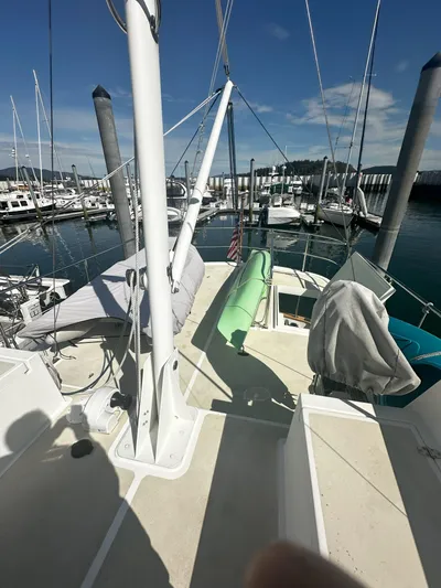 Brut Yacht Photos Pics 1999 Krogen Trawler docked at a marina under a clear blue sky.