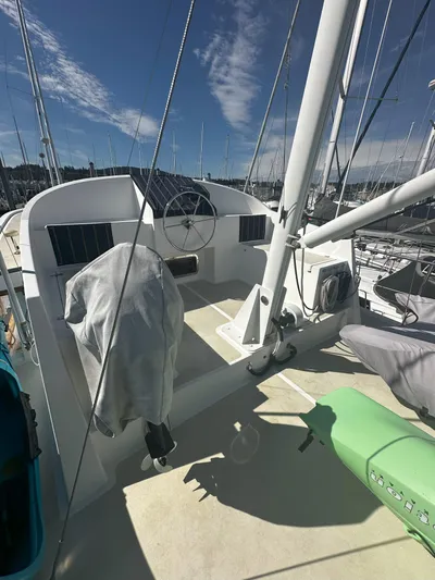 Brut Yacht Photos Pics 1999 Krogen Trawler deck with steering wheel and covered equipment under clear sky.