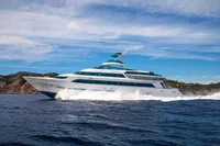 Luxurious Devonport yacht cruising on open sea, 2014 model, with scenic coastal backdrop.