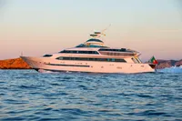 Luxurious Devonport yacht cruising at sunset, 2014 model, with scenic ocean backdrop.