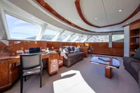 Luxurious yacht interior with elegant wood finishes, large windows, and comfortable seating, Devonport 2014 model.
