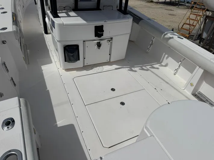  Yacht Photos Pics 2016 Everglades 355 Tournament boat deck with storage compartments and seating.