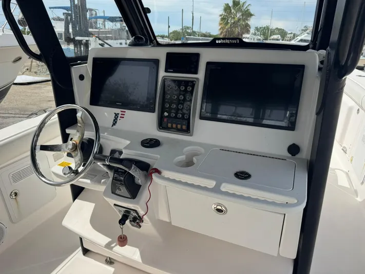  Yacht Photos Pics 2016 Everglades 355 Tournament boat dashboard with steering wheel and navigation screens.