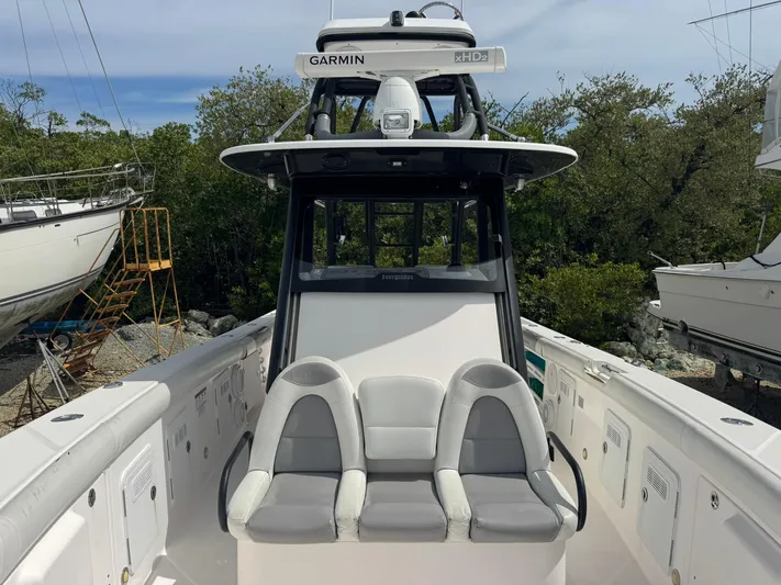 Yacht Photos Pics 2016 Everglades 355 Tournament boat with Garmin equipment, docked near trees.