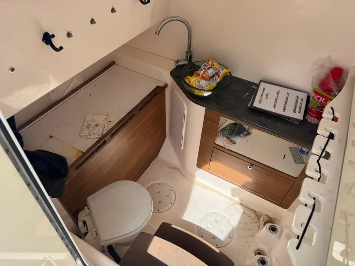  Yacht Photos Pics Interior of 2016 Everglades 355 Tournament boat with compact bathroom and storage.
