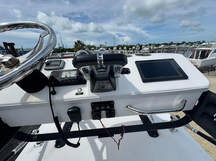  Yacht Photos Pics Control panel of 2016 Everglades 355 Tournament boat with steering wheel and navigation equipment.