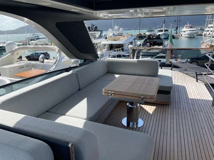  Yacht Photos Pics Luxurious 2022 Cranchi Settantotto 78 yacht with elegant outdoor seating and scenic marina view.