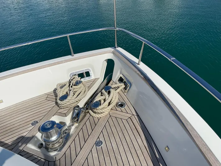  Yacht Photos Pics Bow of 2022 Cranchi Settantotto 78 yacht with ropes and winches on teak deck.