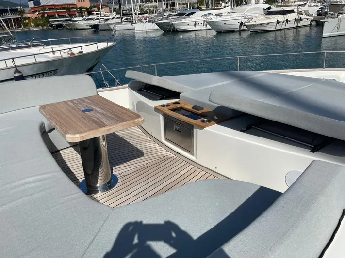  Yacht Photos Pics 2022 Cranchi Settantotto 78 yacht deck with seating and table, docked in marina.
