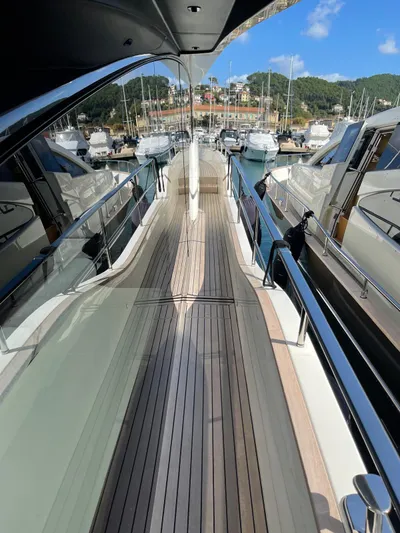  Yacht Photos Pics 2022 Cranchi Settantotto 78 yacht docked in a marina, showcasing sleek deck design.