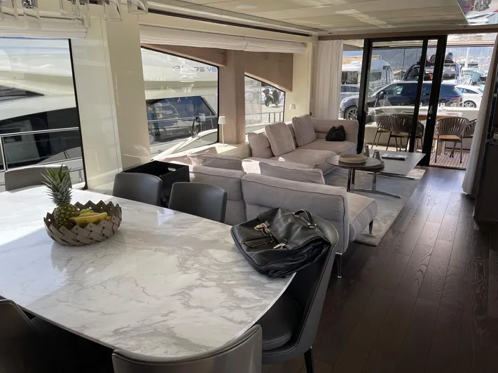  Yacht Photos Pics Luxurious interior of 2022 Cranchi Settantotto 78 yacht with elegant dining and seating area.