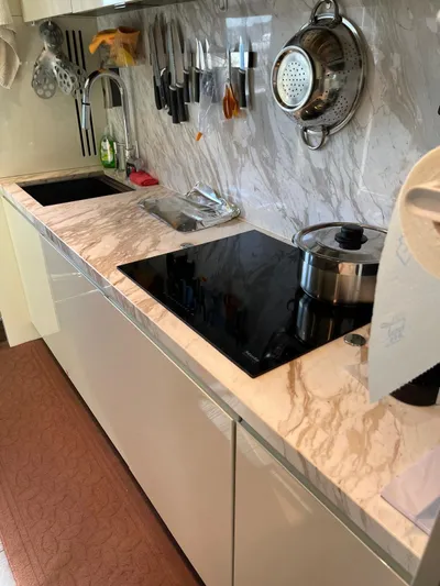  Yacht Photos Pics Modern kitchen in 2022 Cranchi Settantotto 78 yacht with marble countertop and sleek appliances.