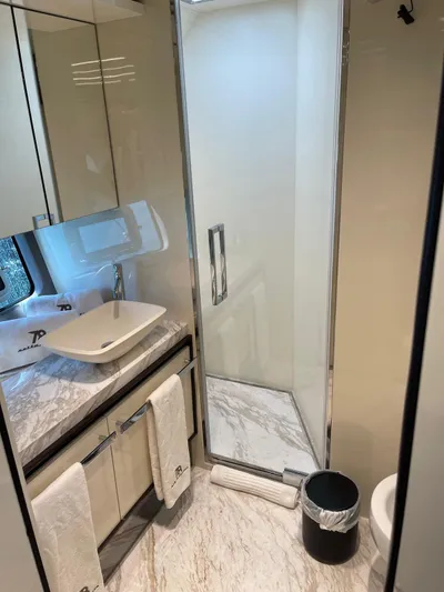  Yacht Photos Pics Luxurious bathroom in 2022 Cranchi Settantotto 78 yacht with modern fixtures and marble accents.