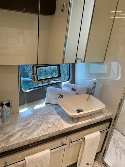  Yacht Photos Pics Luxury bathroom in 2022 Cranchi Settantotto 78 yacht with marble countertop and modern sink.