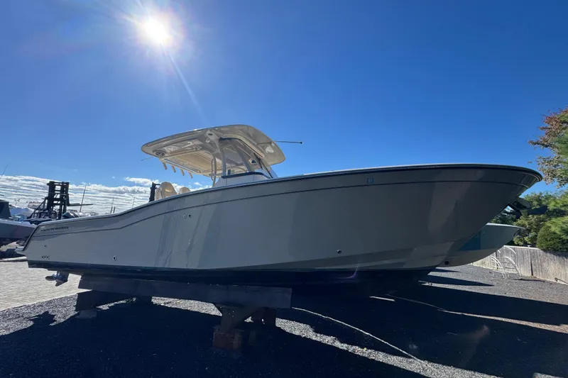  Yacht Photos Pics 2022 Grady-White Canyon 326 boat under bright sun, displayed on a stand.