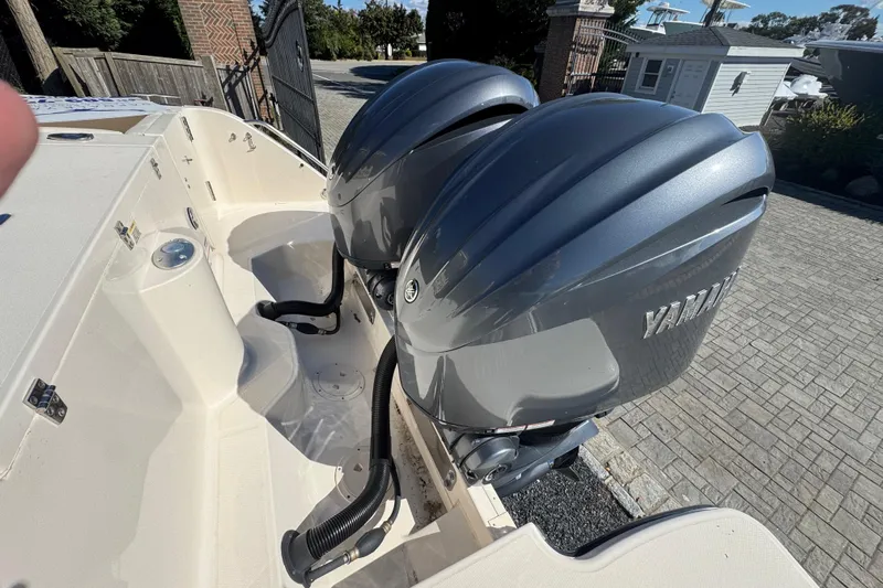  Yacht Photos Pics 2022 Grady-White Canyon 326 with dual Yamaha outboard engines, parked on a paved driveway.