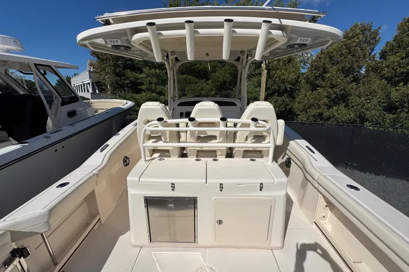  Yacht Photos Pics 2022 Grady-White Canyon 326 boat interior with seating and storage, under clear blue sky.