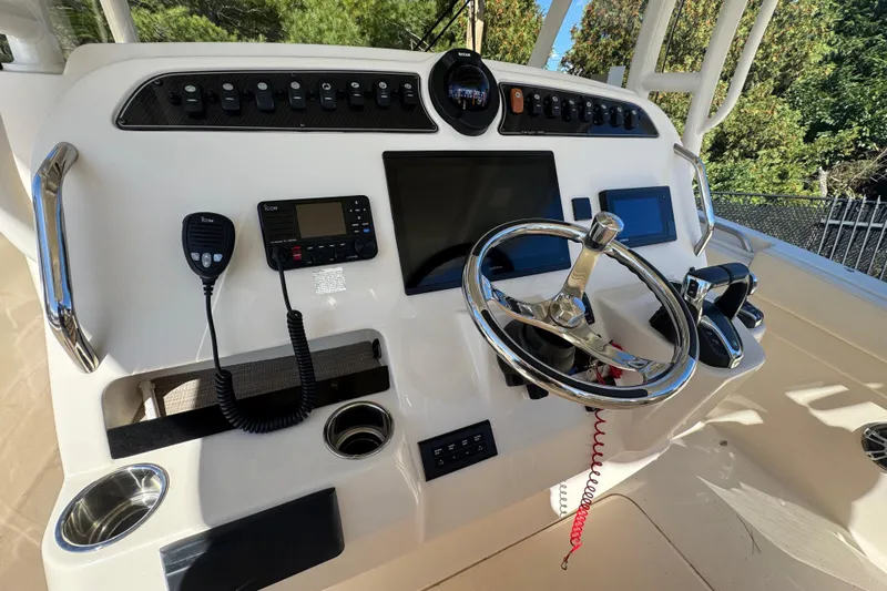  Yacht Photos Pics 2022 Grady-White Canyon 326 helm with steering wheel and navigation controls.
