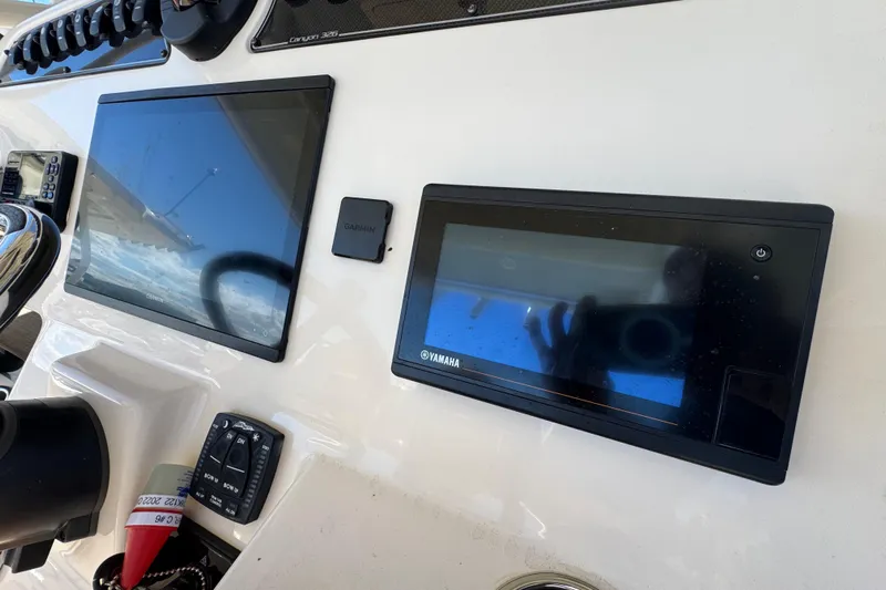 Yacht Photos Pics Control panel of 2022 Grady-White Canyon 326 boat with Garmin and Yamaha displays.