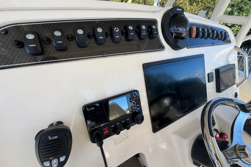  Yacht Photos Pics 2022 Grady-White Canyon 326 helm with controls, compass, and navigation display.