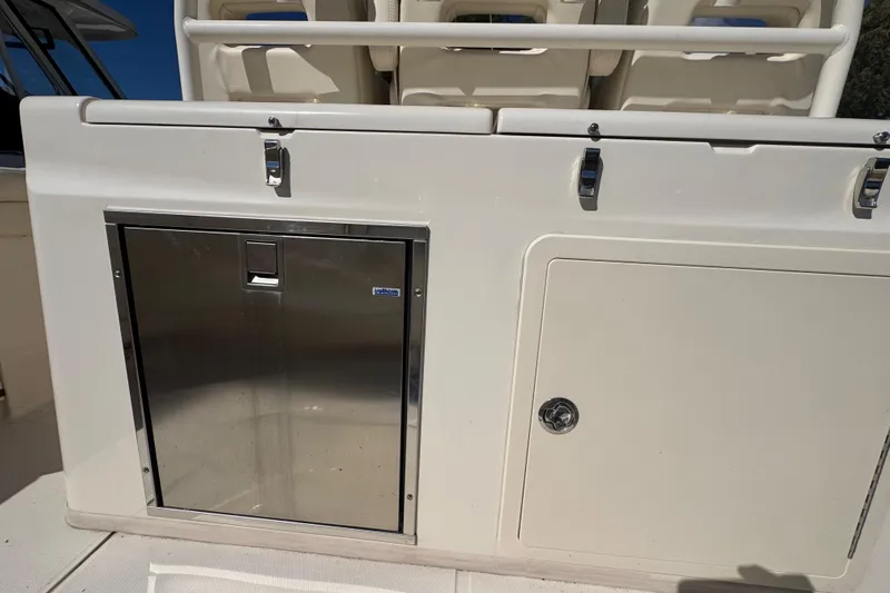  Yacht Photos Pics 2022 Grady-White Canyon 326 boat interior with storage compartments and stainless steel door.