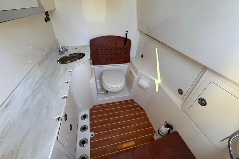  Yacht Photos Pics 2022 Grady-White Canyon 326 boat interior with toilet and sink.