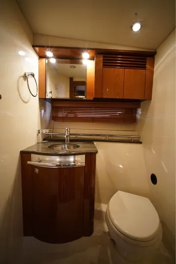  Yacht Photos Pics Luxurious bathroom in 2012 Sea Ray 500 Sundancer yacht with modern fixtures and wood accents.