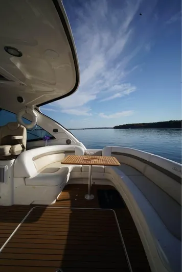  Yacht Photos Pics 2012 Sea Ray 500 Sundancer yacht deck with seating and table, overlooking calm waters.